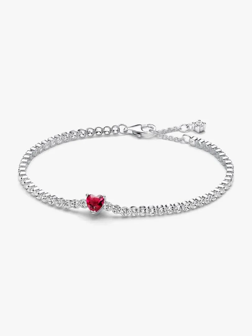Tennis bracelet arranged in a circle on a white background, front view highlighting the red heart stone.
