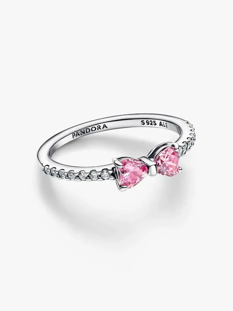 Side view of the bow ring with pink cubic zirconia, centered on a white background.
