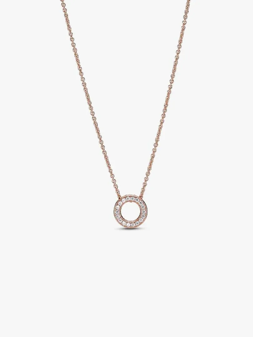 Rose gold circle pendant necklace centered on a white background, front view.