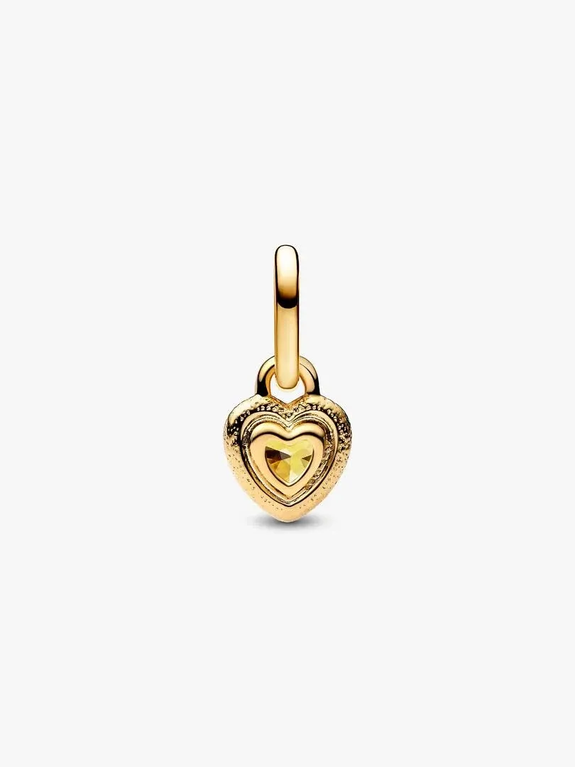 Front view of the heart pendant with yellow cubic zirconia on a white background.