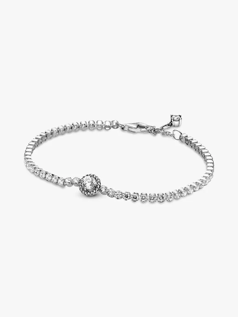 Pulsera de tenis dispuesta en forma circular sobre fondo blanco, vista frontal con detalle del cierre.