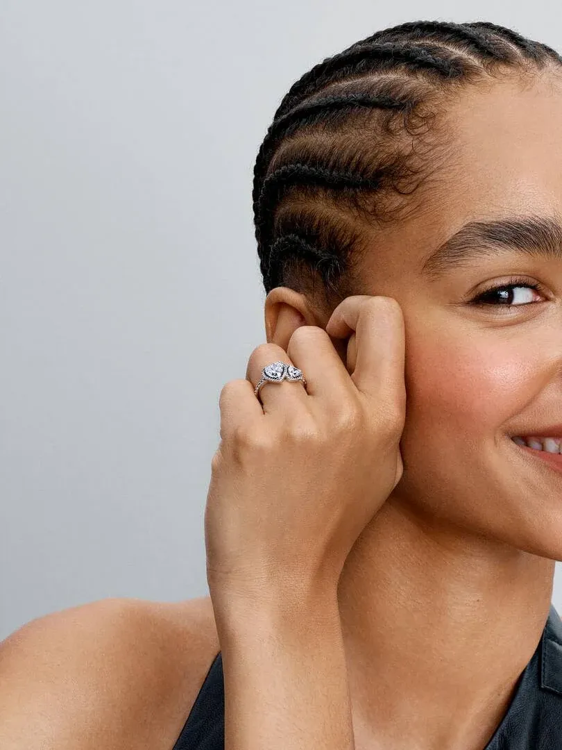 Close-up of the heart-shaped stone ring worn on a finger, side view on a model.