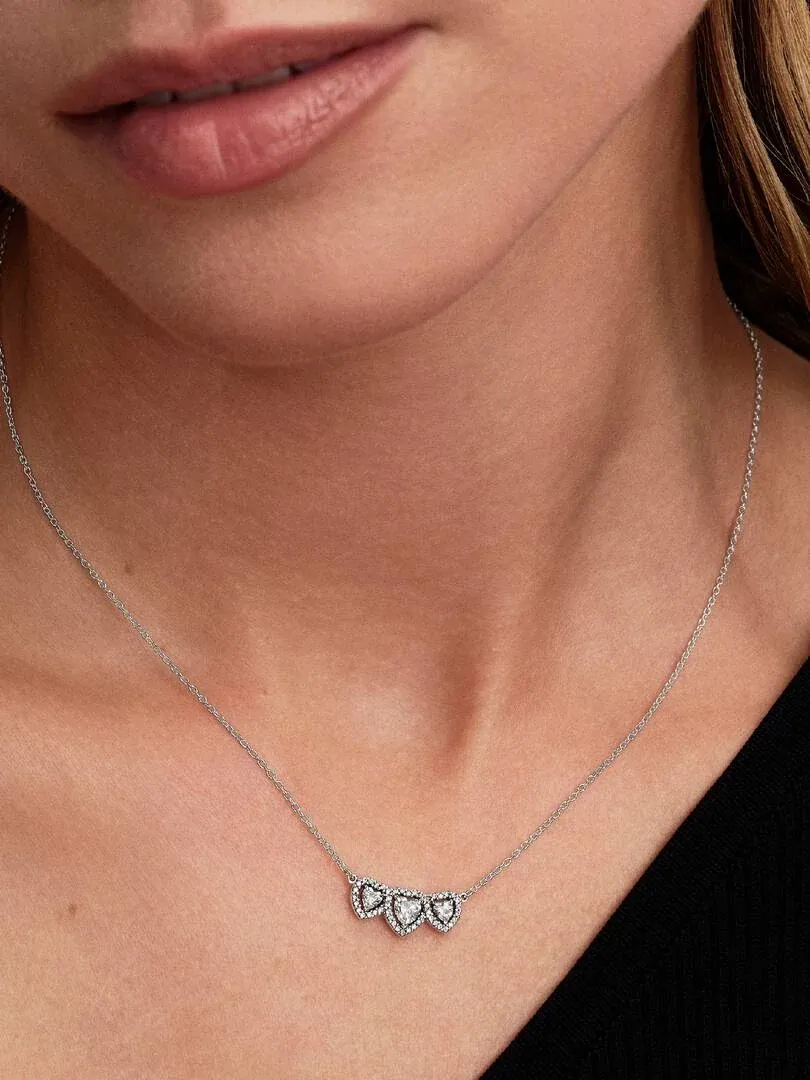 Gros plan du collier cœur sur le cou d'un mannequin, vue de face avec arrière-plan flou.