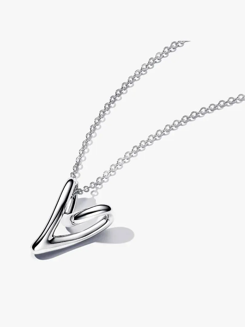 Silver necklace with organic heart pendant, angled shot on a white background with soft shadow.