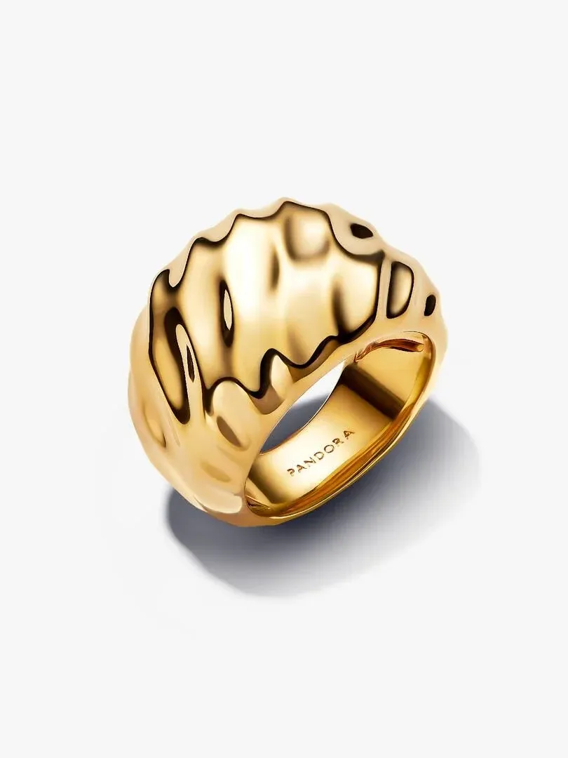 Anillo dorado con diseño ondulado visto en ángulo tres cuartos, sobre fondo blanco con sombra suave.