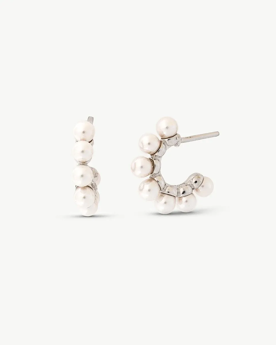 Front view of hoop earrings with pearls on a white background, showing the post and curvature.
