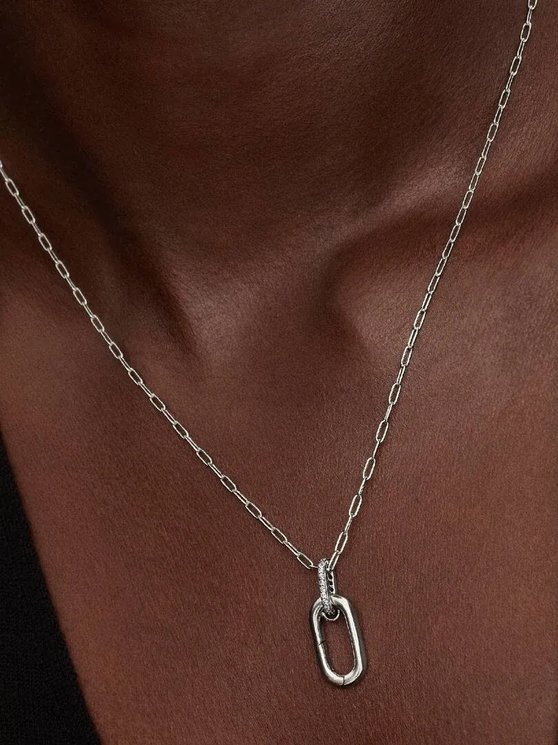 Close-up of the link necklace on a model's neck, front view with dark background.