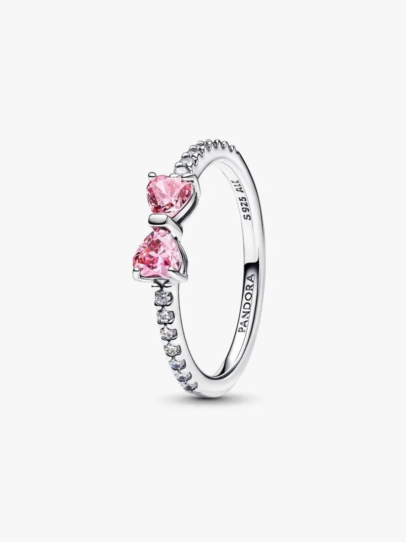 Side view of the bow ring with pink cubic zirconia, isolated on a white background.