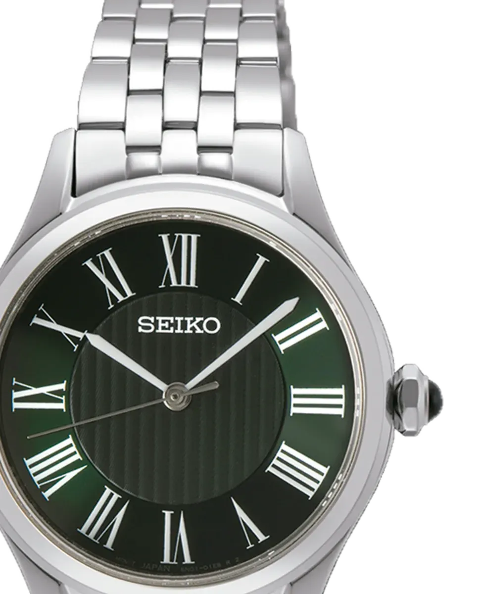 Front close-up of the green dial with Roman numerals and crown, white background.