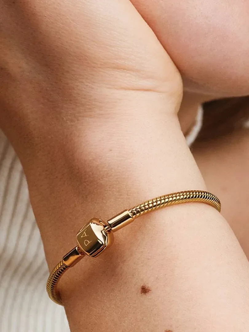 Close-up of the bracelet with barrel clasp on a wrist, side view with blurred background.
