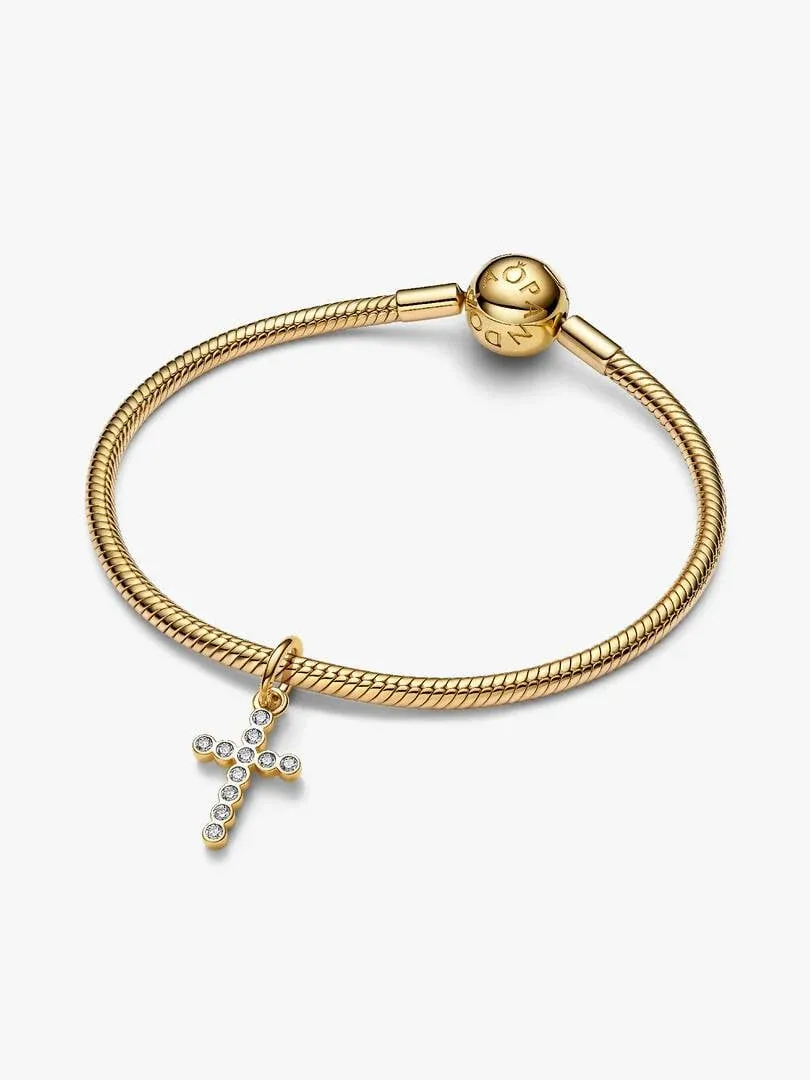 Gold chain bracelet with cubic zirconia cross charm, front view on a white background.