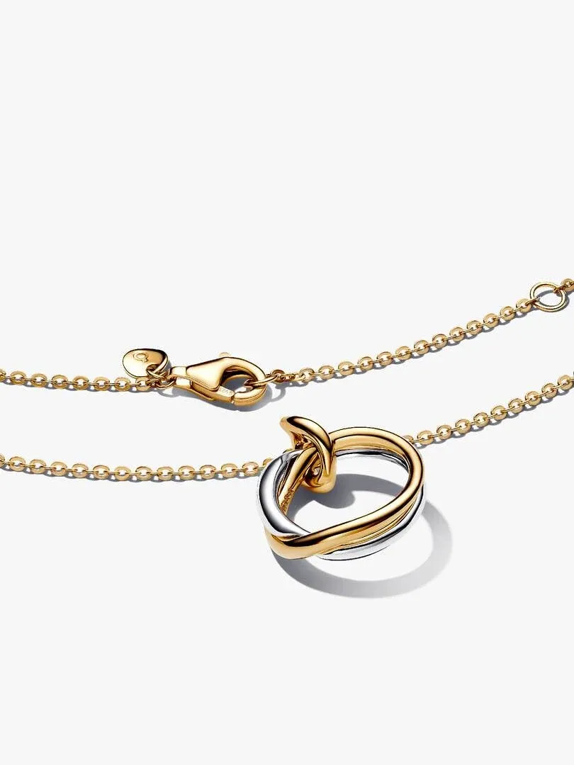 Two-tone necklace with organic pendant on white background, front view showing chain and clasp detail.