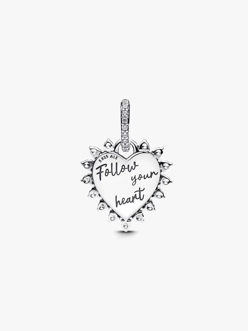 Front view of heart charm with inscription on white background, showing arrow and pavé stones.