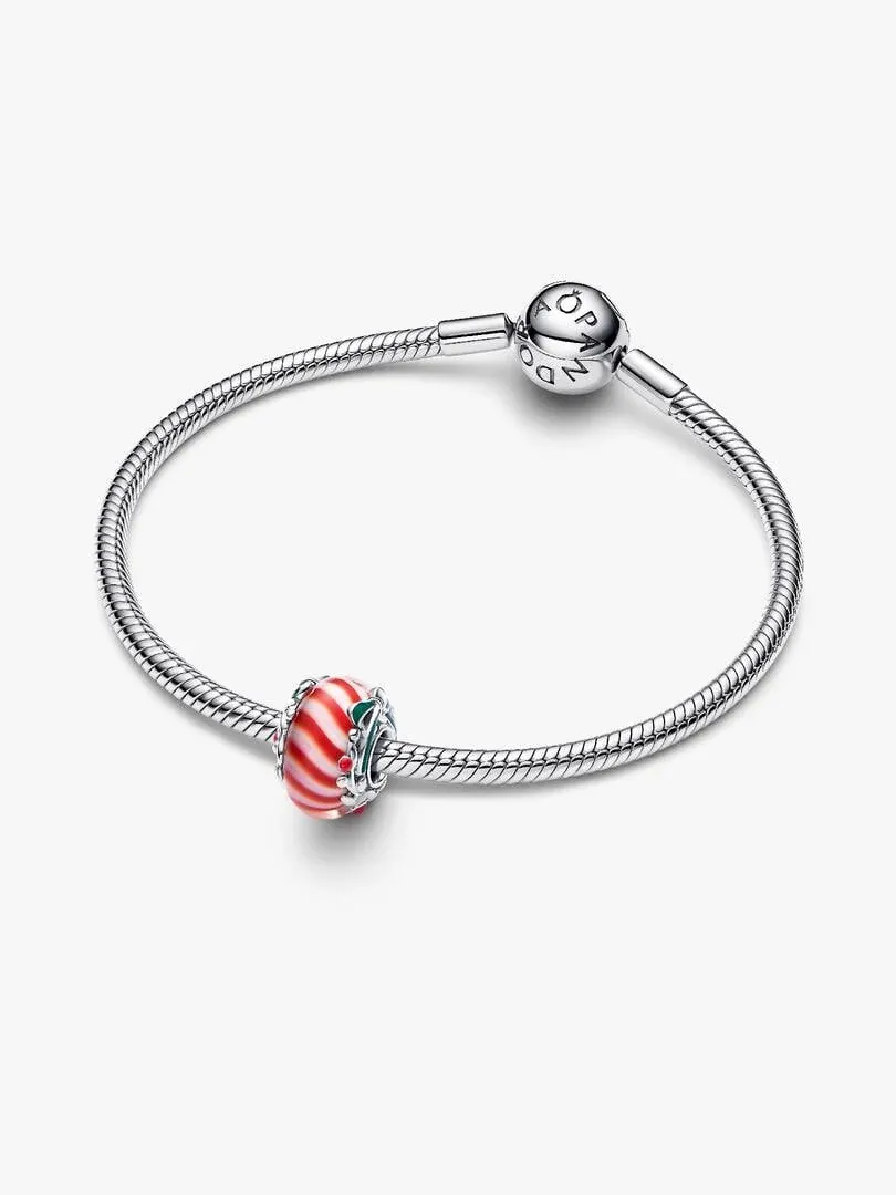 Red and white Murano glass charm on a silver bracelet, top view on a white background.