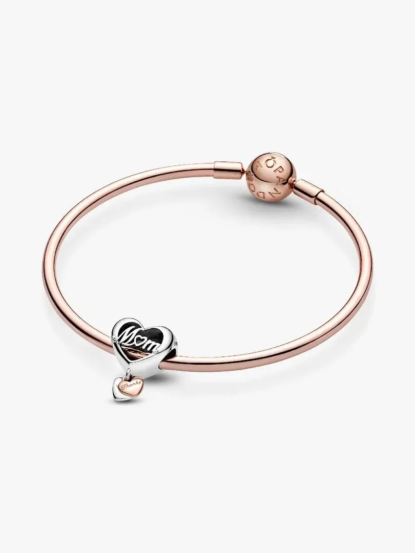 Front view of the bangle bracelet with heart charm, slightly high angle on a white background.