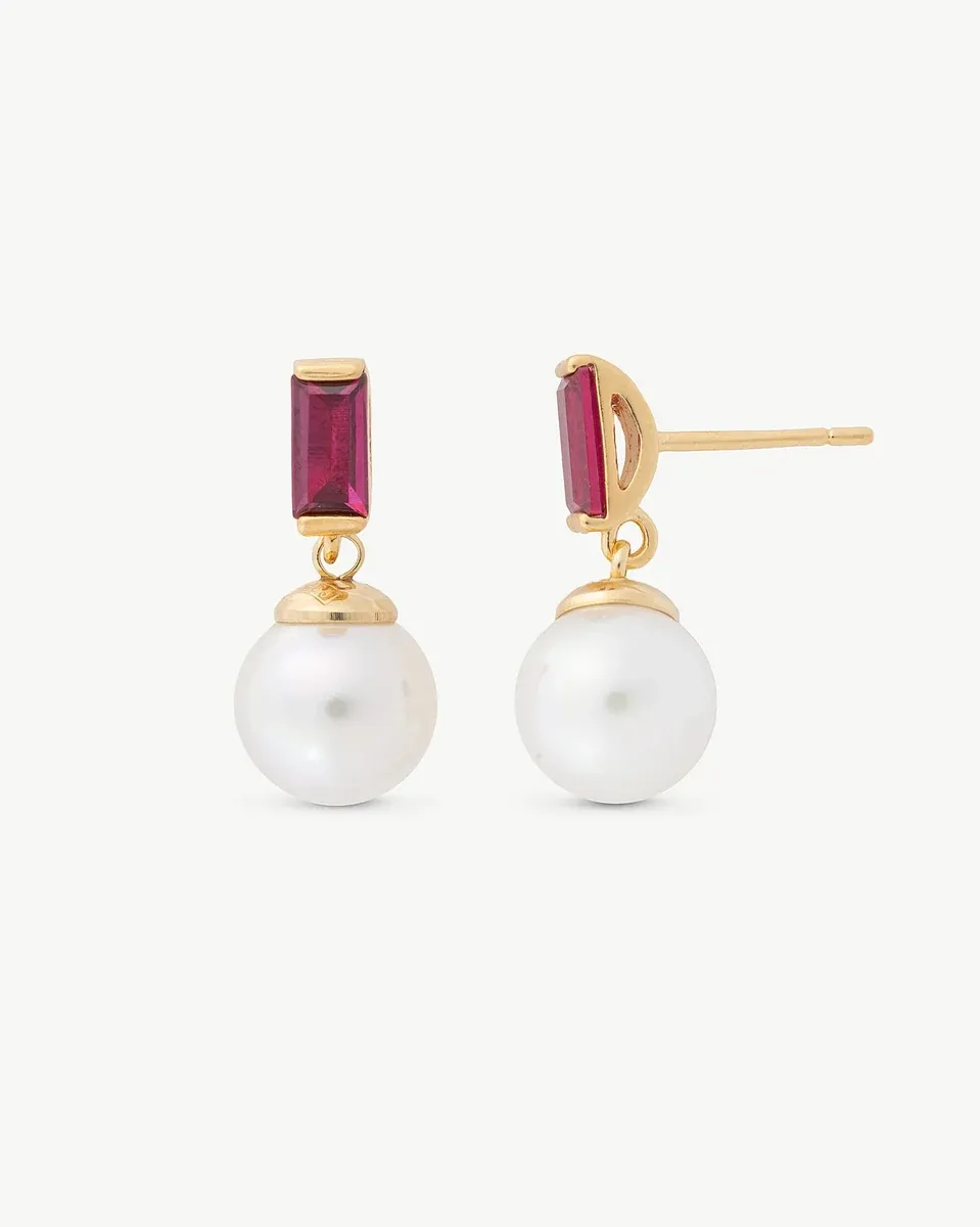 Front view of pearl and red zircon earrings on a white background.