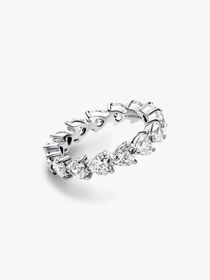 Eternity ring shown from a side angle, white background, close-up of heart-shaped stones.