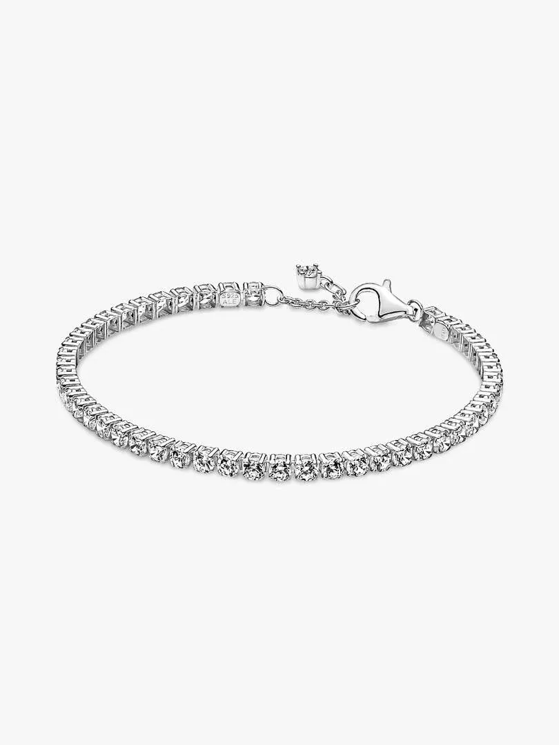 Tennis bracelet shown at a side angle on a white background, displaying the stone row and clasp.