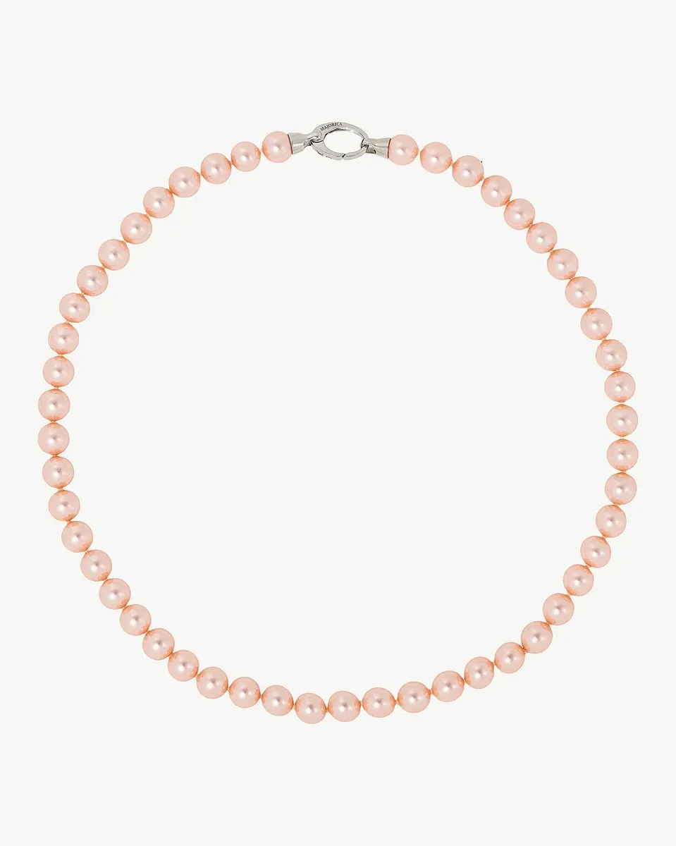 Pink pearl necklace arranged in a circular shape on a white background, full frontal view.