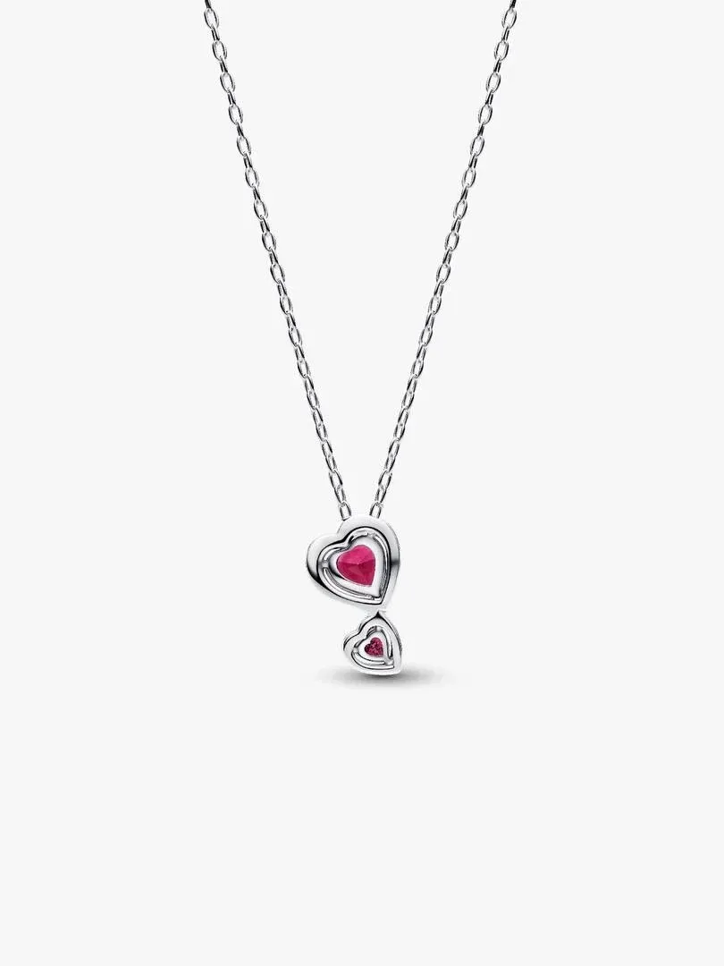 Silver necklace with two red heart pendants, front view on a white background.