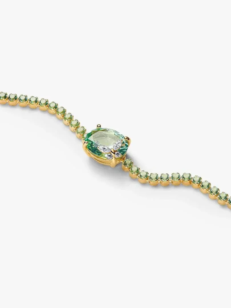 Diagonal view of the bracelet with green crystals and center stone, on a white background.