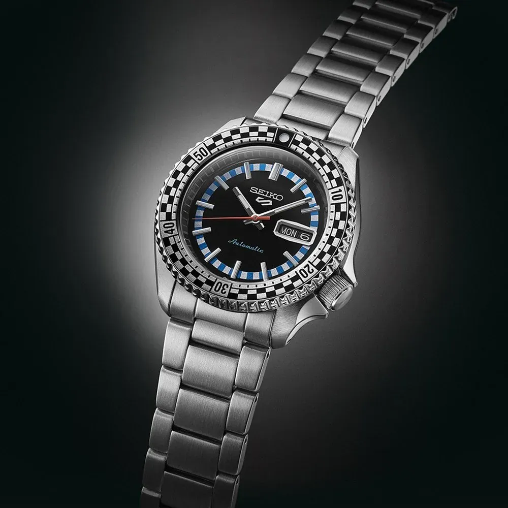 Perspective view of the watch on a dark gradient background, showing the dial and steel bracelet.