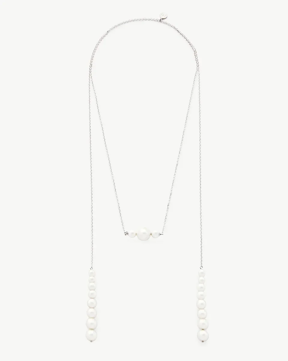 Long silver necklace with white pearls, full front view on a neutral white background.