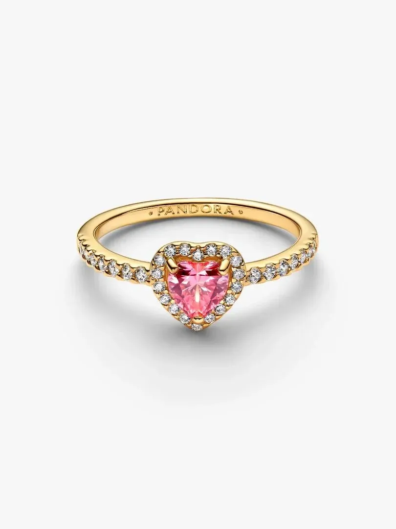Gold ring with pink heart-shaped center stone, front angled view on a white background.