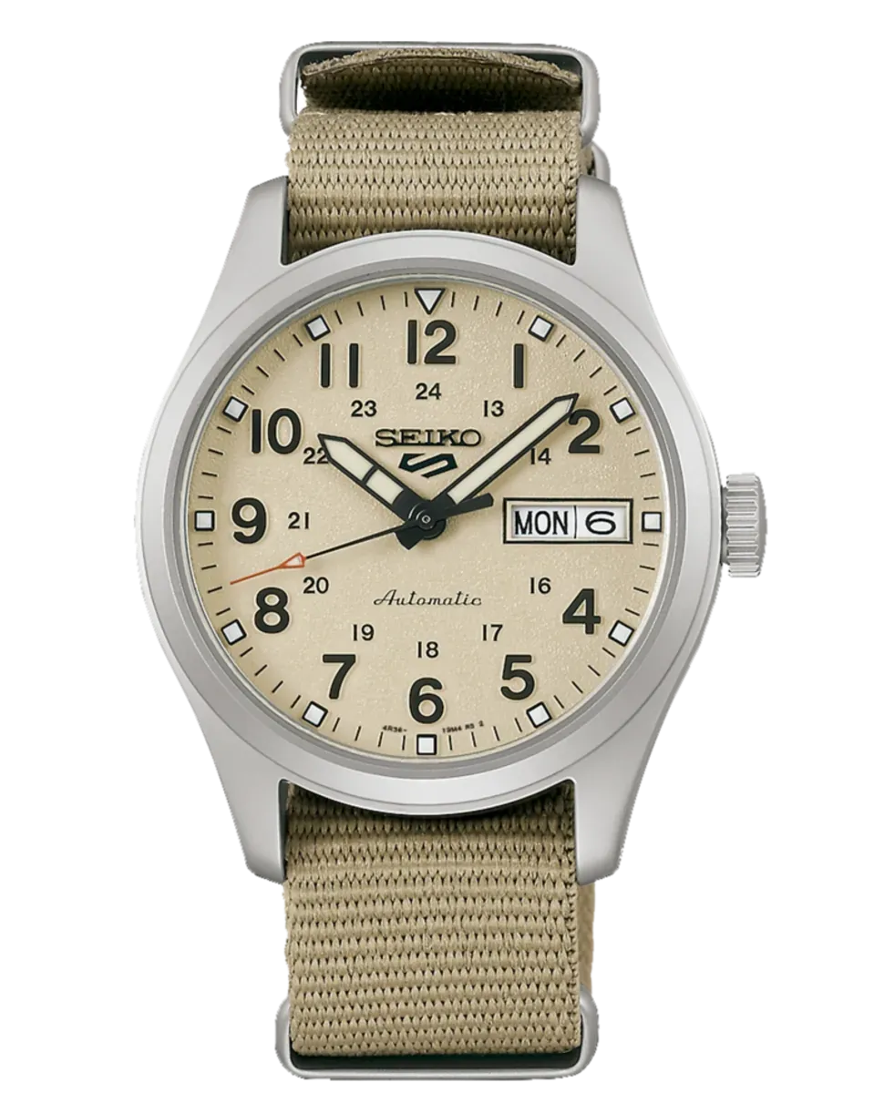 Vista frontal del reloj con esfera beige y correa de nylon, sobre fondo blanco.