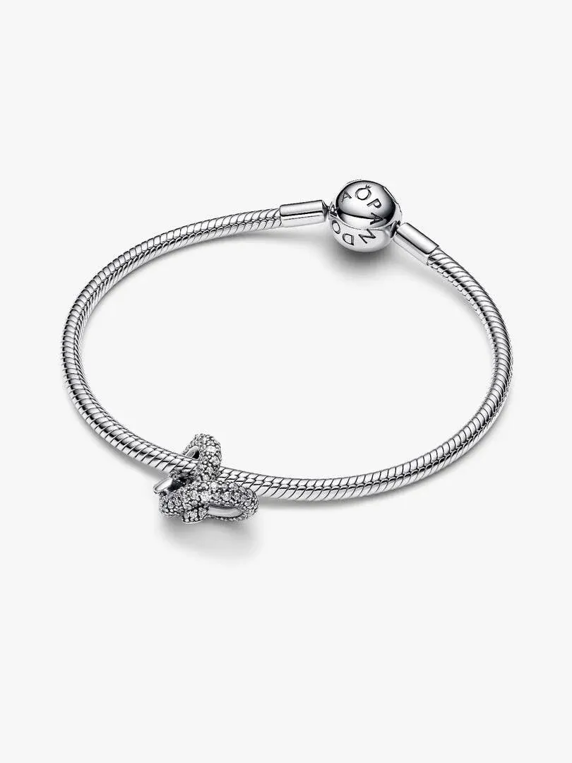 Silver bracelet with heart charm shown from a side angle on a white background.