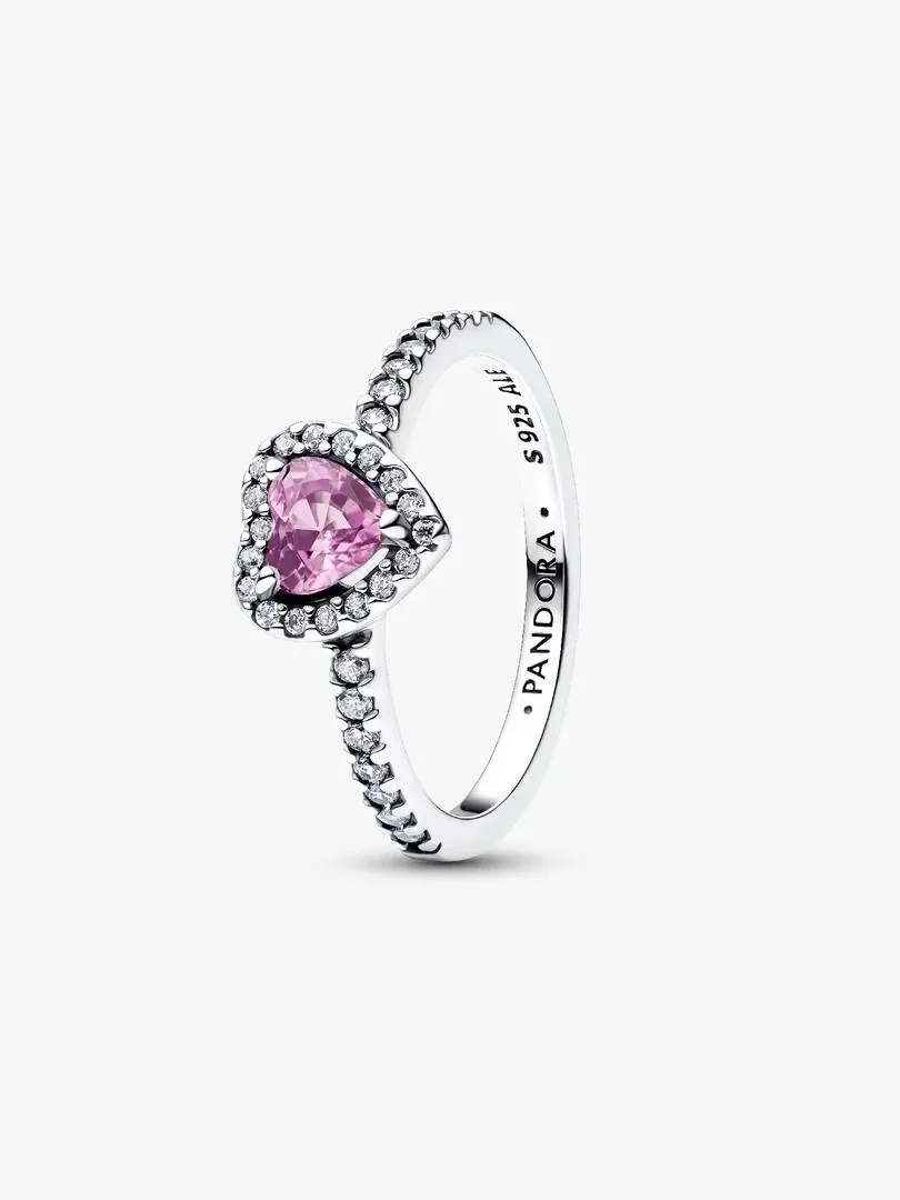 Side angle view of a lilac heart ring with pavé halo on a white background.