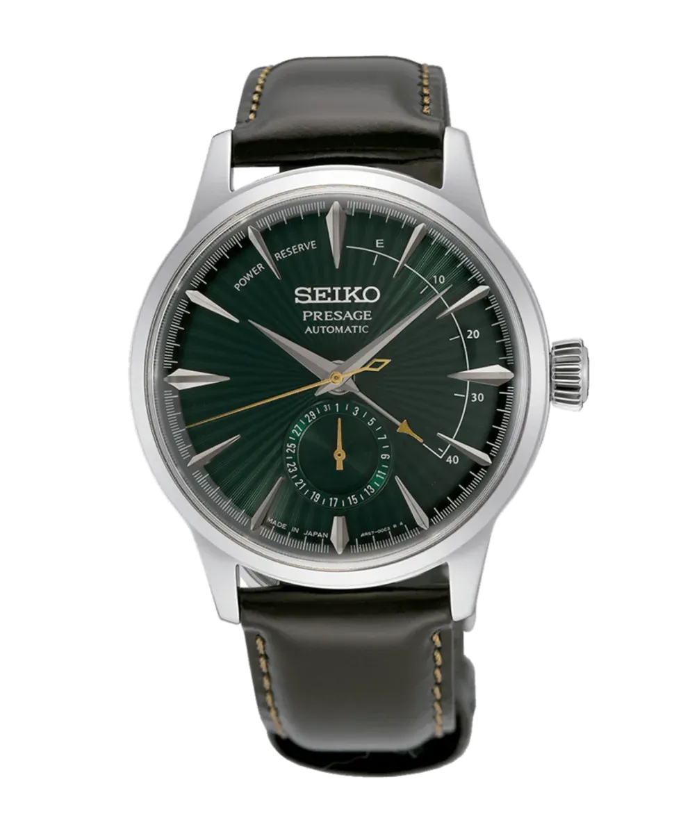 Vista frontal completa del reloj con esfera verde y correa de piel oscura sobre fondo blanco.