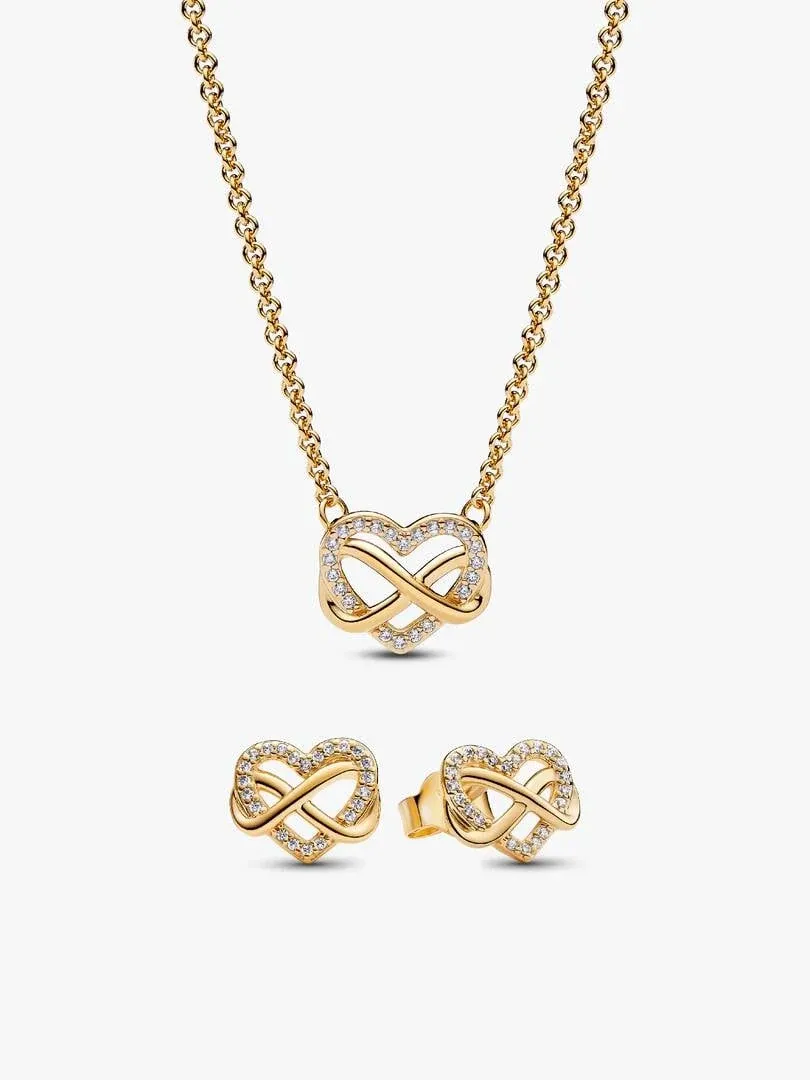 Heart necklace and stud earrings with filigree on a white background, centered front view.