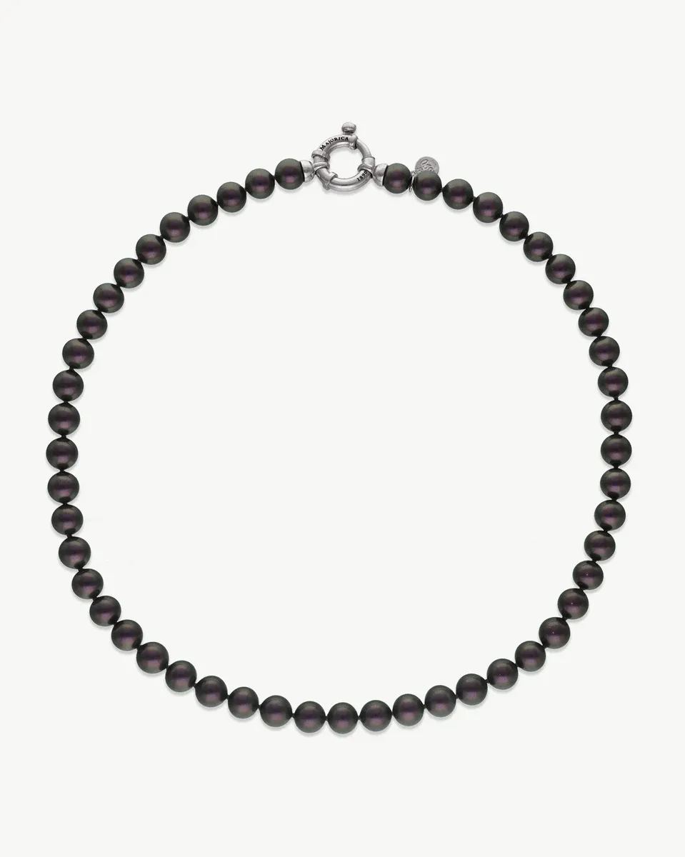 Black pearl necklace arranged in a circular shape on a white background, full front view.