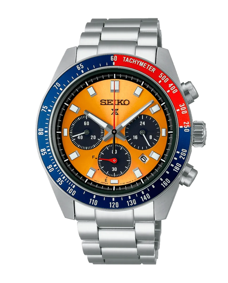 Vista frontal del reloj sobre fondo blanco, destacando la esfera naranja y el bisel taquimétrico bicolor.