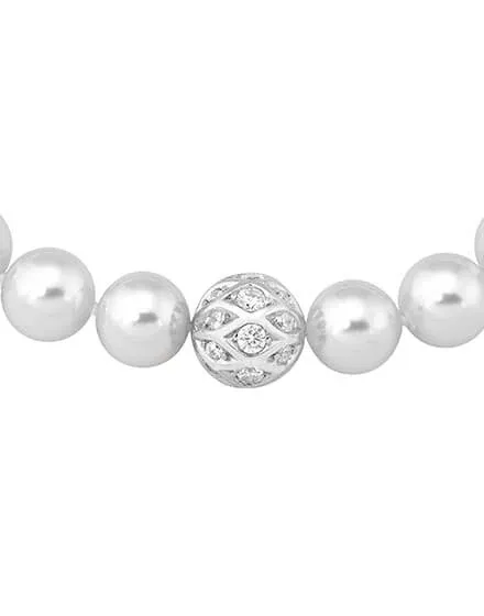 Primer plano horizontal de la esfera central con circonitas y perlas blancas, fondo blanco.