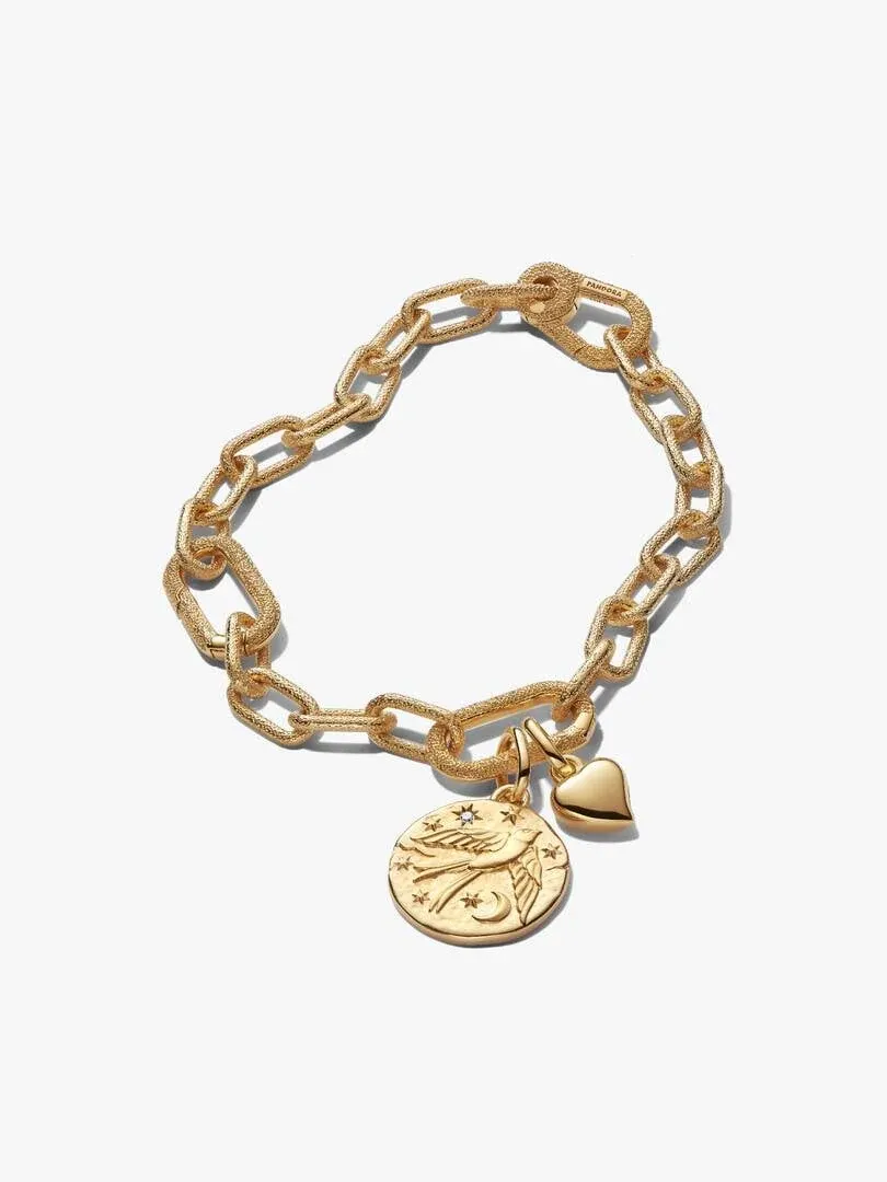 Gold-tone link bracelet with heart and circular medallion charms, front view on a white background.