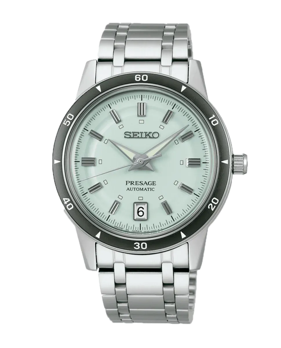 Vista frontal del reloj con esfera verde claro y brazalete de acero sobre fondo blanco.
