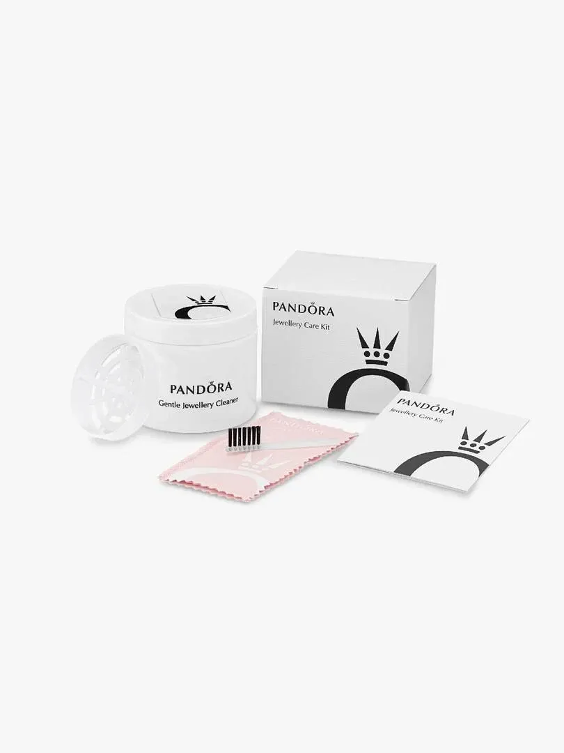Pandora jewelry care kit with cleaner bottle, white box, and polishing cloth on a white background, high-angle view.