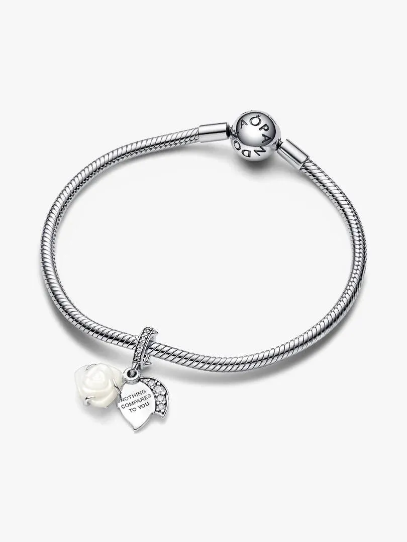 Silver bracelet with white rose hanging charm, front view on a white background.