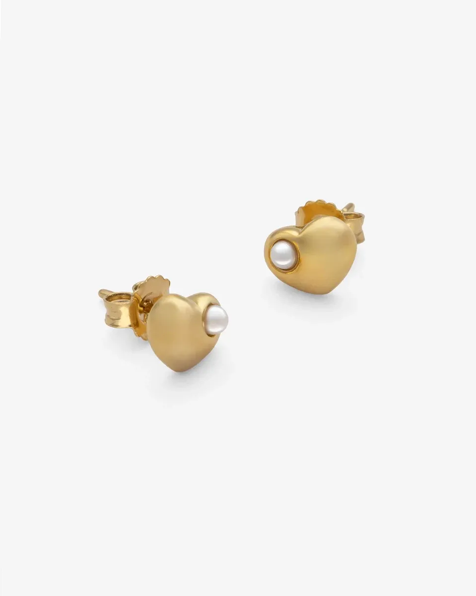 Pair of gold heart earrings with pearl, angled front view on a white background.