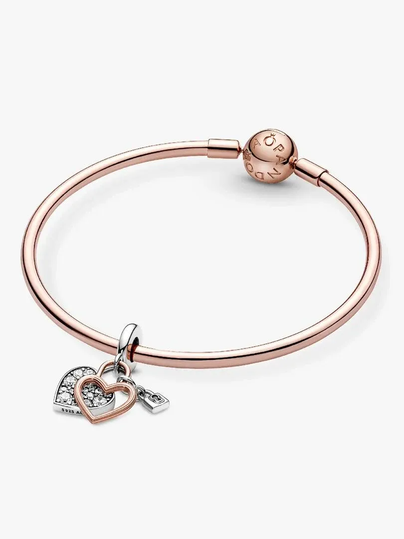 Front view of the bracelet with hanging charms on a white background, slightly high angle shot.