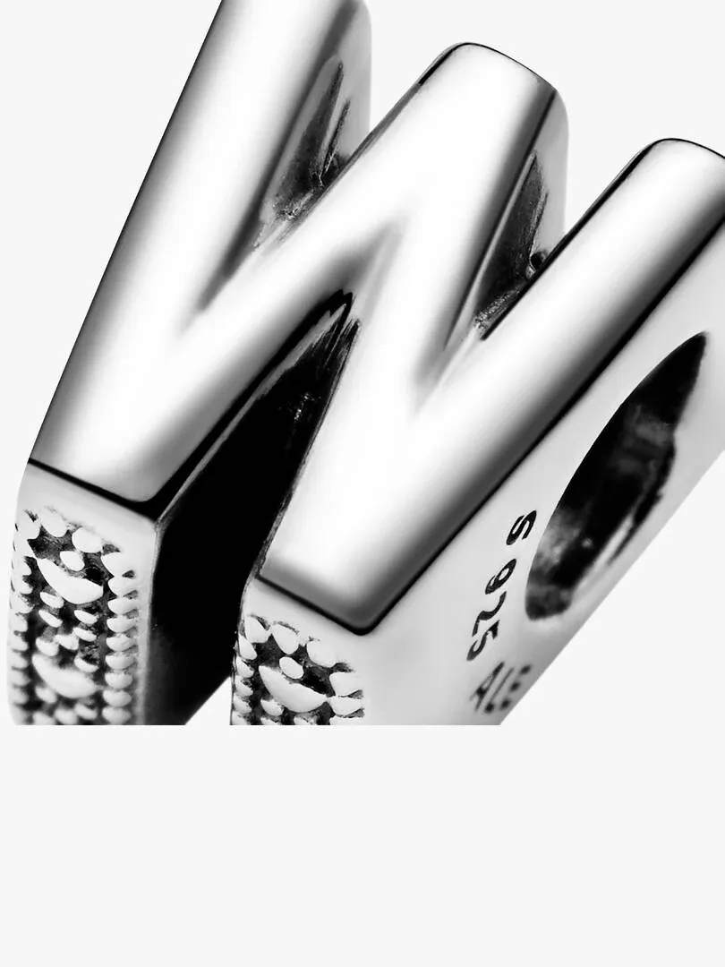 Close-up of the silver letter W, side angle showing S925 engraving, white background.