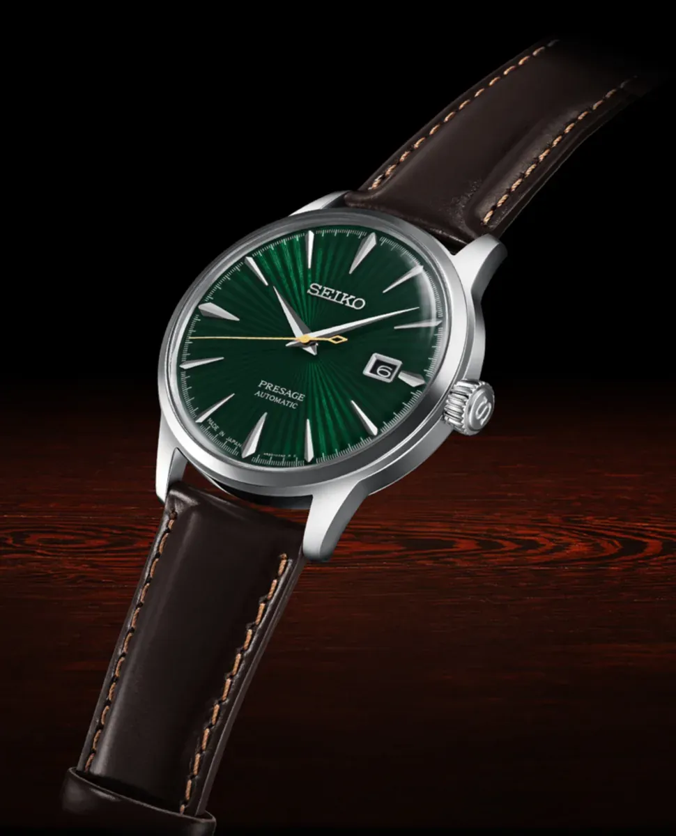 Perspective view of the watch on a dark wood surface against a black background.
