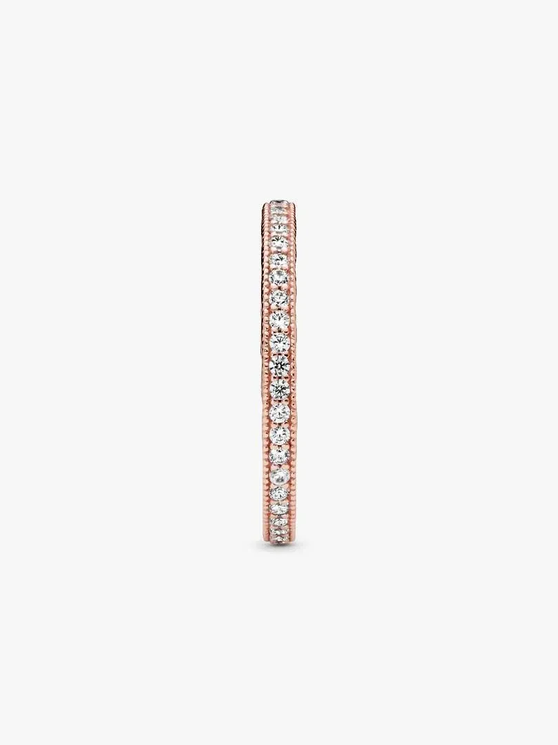 Rose gold ring side view, white background, close-up of the pavé cubic zirconia band.