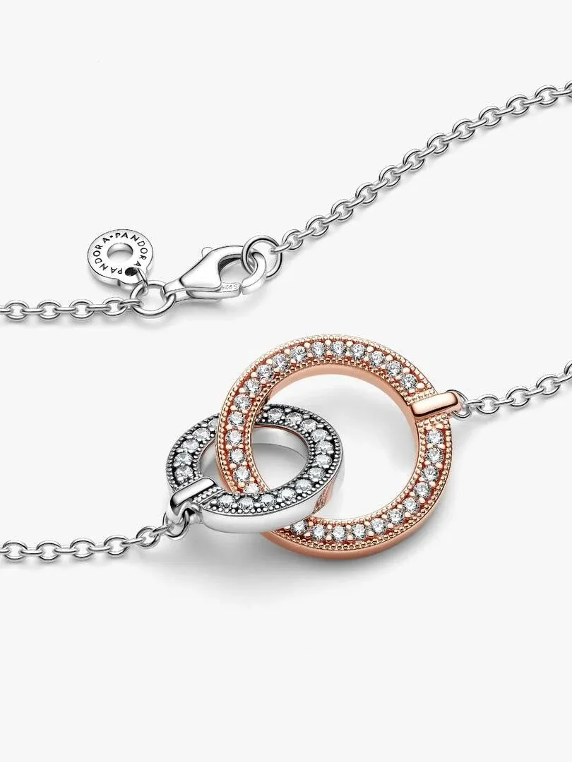 Front view of the necklace with two interlocking silver and rose gold circles on a white background.