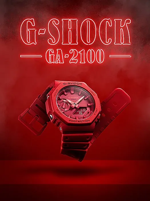 Reloj rojo flotando sobre fondo rojo atmosférico con texto de neón 'G-SHOCK GA-2100' en la parte superior.