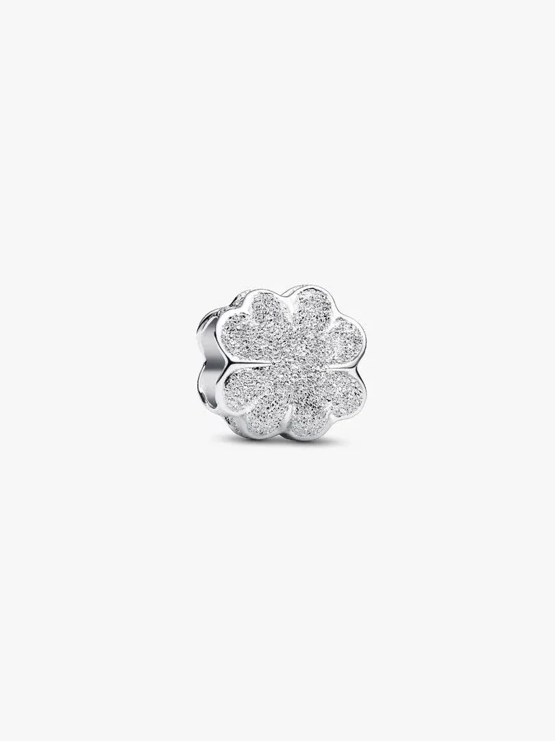 Textured clover charm, front angled view, isolated on pure white background.