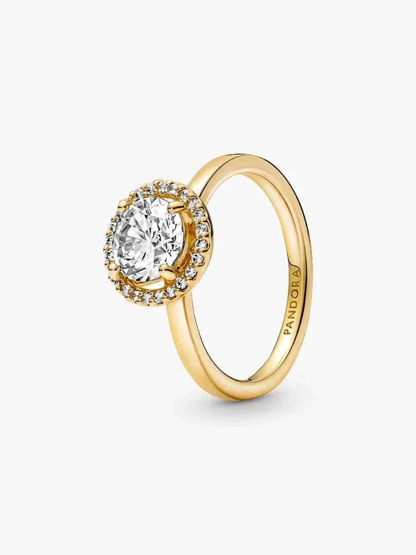 Gold ring with center stone and halo, angled side view on a white background.
