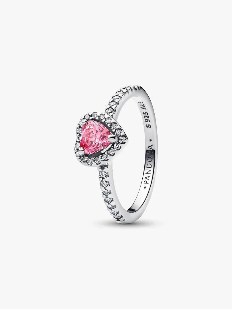 Pink heart ring shown from a side angle, white background, detail of the pavé setting and silver band.